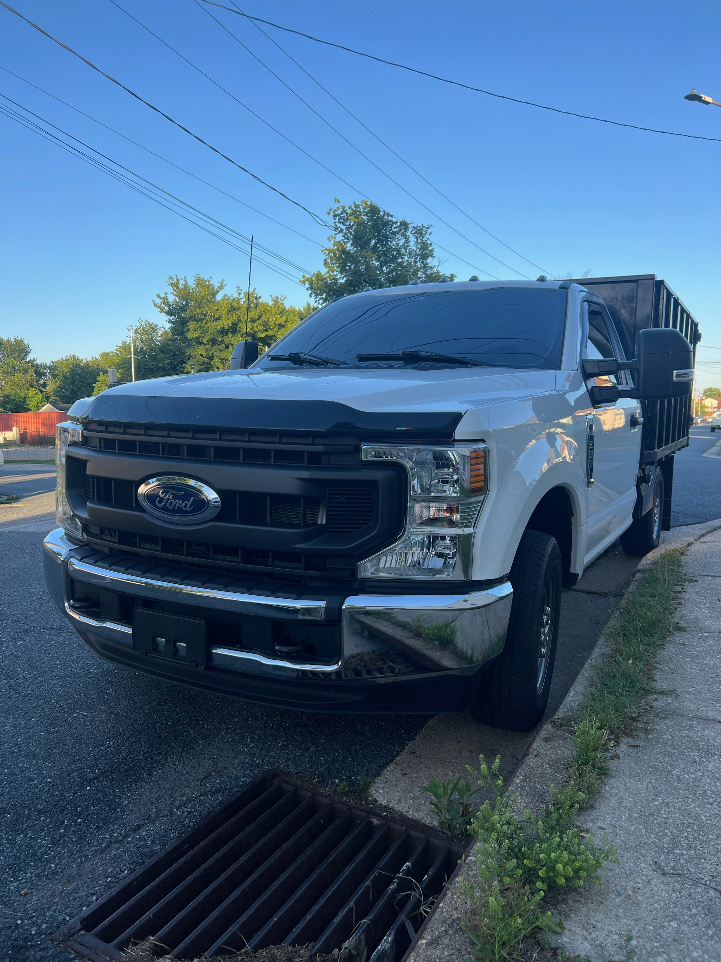 Junk Pro’s | Same Day Services orange dump truck loaded with furniture and debris